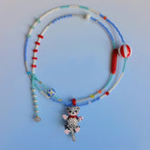 Necklace with a tabby cat charm on a light blue background
