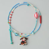 Beaded necklace with a beagle dog charm on a gray background