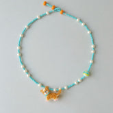 Necklace with a Corgi dog charm on a light gray background