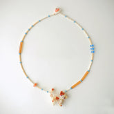 beaded Necklace with Calico cat charm on a white background