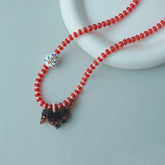 Handmade Dachshund dog necklace with christmas charm on a light gray background - verhalo jewelry