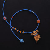 Beaded necklace with a cocker spaniel dog charm on a black background- verhalojewelry