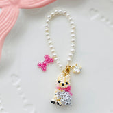 Pearl bag charm with a Yorkie dog pendant and decorative elements on a white background