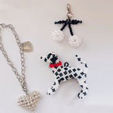 Set of beaded Dalmatian dog charm, heart-shaped pendant, and cherry-shaped keychain on a white background - Verhalo jewelry