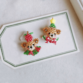 Pair of Christmas Bear Stud earrings on a white card with green border