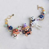 Halloween party Colorful beaded bracelet with animal charms on a light gray background