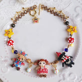 Colorful beaded birthday party necklace with character charms on a white plate