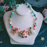 Handmade Colorful beaded Christmas spirit necklace with snowman, Santa,  Gingerbread Man figures on a white stand.- verhalo custom jewelry