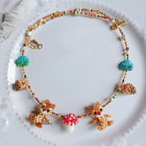 Handmade Necklace with squirrel and mushroom charms on a white plate - verhalo custom jewelry