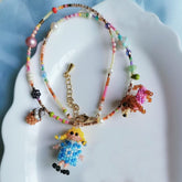 Handmade colorful beaded necklace with a girl and a dog on a white dish - verhalo custom jewelry