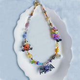 Colorful beaded Halloween bag charm on a white plate - Verhalo custom jewelry