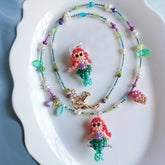 Colorful beaded necklace with mermaid charms on a white plate丨Verhalo Custom Jewelry