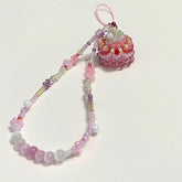 Colorful beaded phone charm on a white background