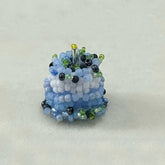 Beaded blueberry cake ring on a light gray background