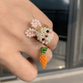 Handmade bunny ring with a carrot charm on a blurred background