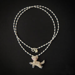 Necklace with a white cat pendant on a black background