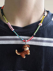 Necklace with a dachshund dog pendant on a person wearing a dark shirt with white stripes. - verhalo handmade jewelry