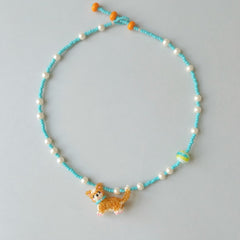 Necklace with a Corgi dog charm on a light gray background