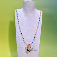 Colorful beaded necklace with a fox terrier dog pendant on a mannequin bust against a green background - verhalo custom jewelry