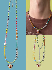 Colorful beaded necklaces with Siamese cat pendants on a blue and green background - Verhalo handmade jewelry