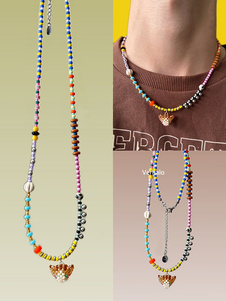 Colorful beaded necklaces with a orange cat charm on a neutral background - Verhalo handmade jewelry
