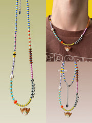 Colorful beaded necklaces with a orange cat charm on a neutral background - Verhalo handmade jewelry
