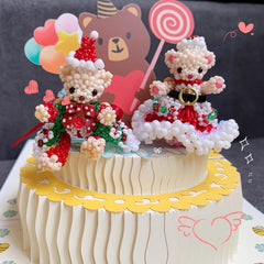 Decorative cake with teddy bear figurines and colorful decorations on a gray background
