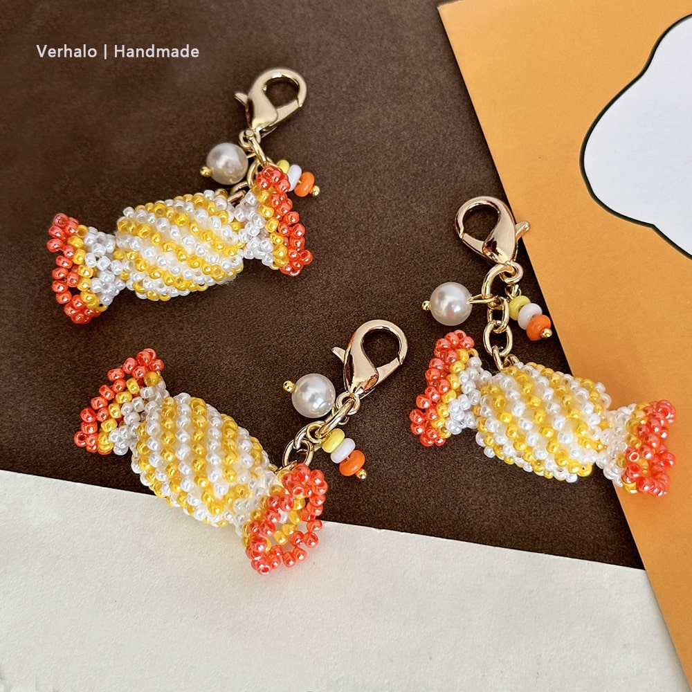 Handmade candy-shaped bag charms with beads on a brown and orange background