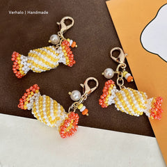 Handmade candy-shaped bag charms with beads on a brown and orange background