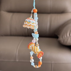 Colorful beaded decoration hanging against a brown sofa background