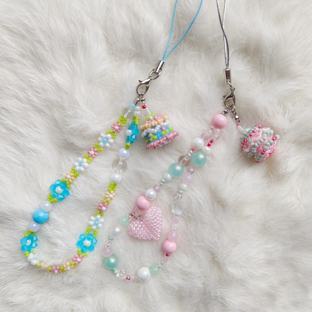 Colorful beaded phone charm on a white furry background