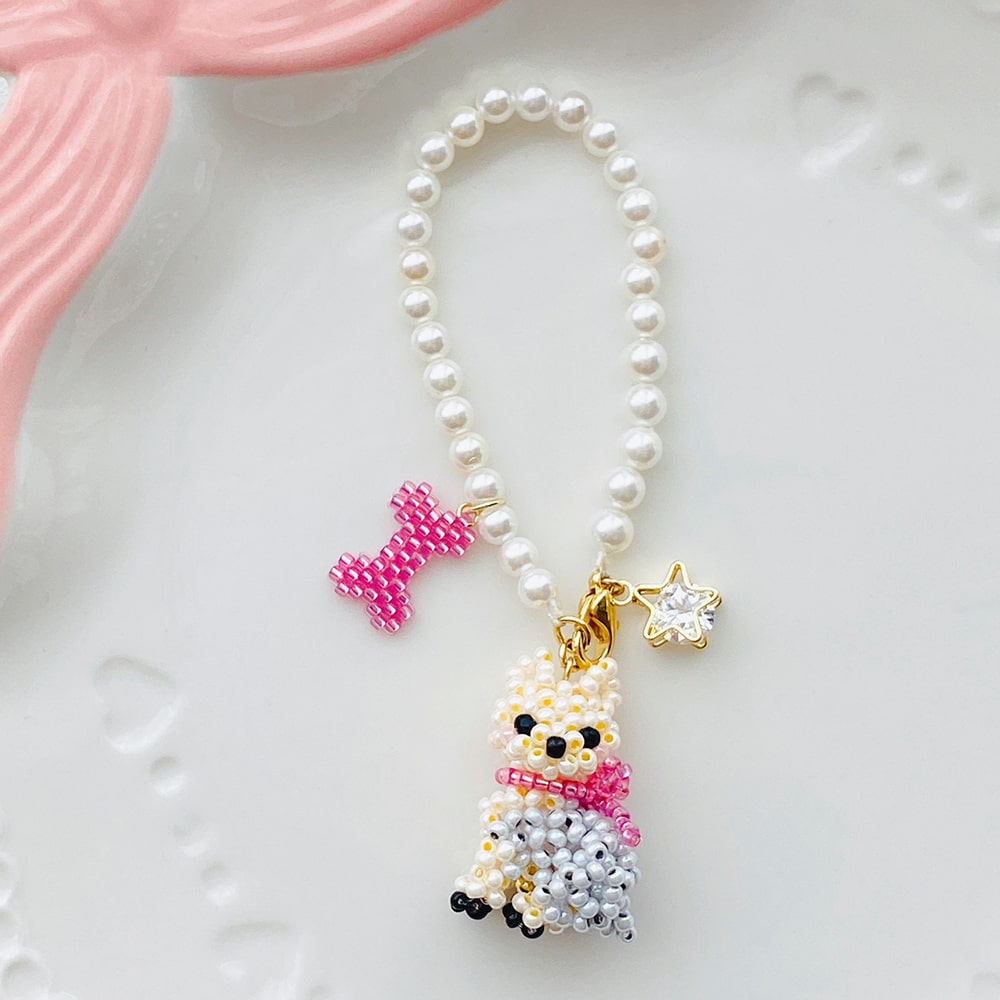 Pearl bag charm with a Yorkie dog pendant and decorative elements on a white background