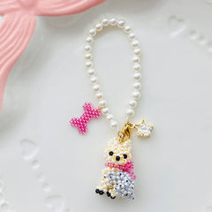 Pearl bag charm with a Yorkie dog pendant and decorative elements on a white background