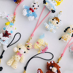 Colorful beaded animal keychains on a white background