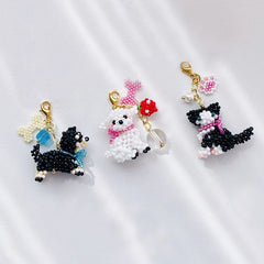 Three handmade custom dog charms on a white background - verhalo jewelry