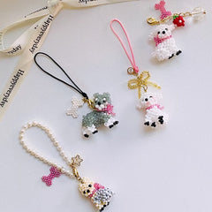 four beaded dog charms on ribbons with a white background