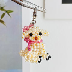 Beaded dog-shaped keychain with a pink scarf on a white background