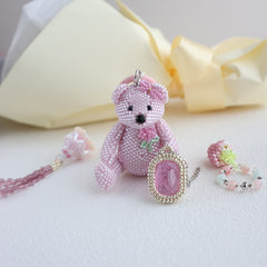 Pink beaded teddy bear keychain with decorative elements on a light - Verhalo jewelrybackground