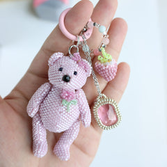 Pink beaded teddy bear keychain held in a hand against a white background - Verhalo jewelry