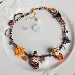Halloween-themed beaded necklace on a textured white surface