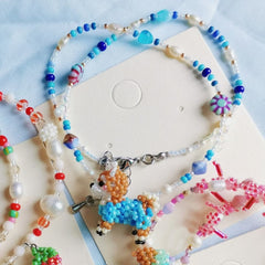 Colorful beaded necklace with a Shiba Inu dog charm on a light blue background