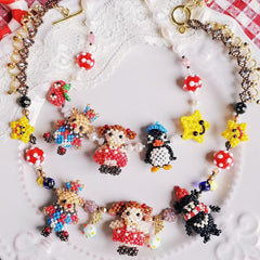 Colorful beaded necklace with animal figures on a white lace background