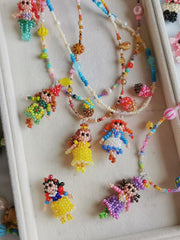 Colorful beaded necklaces with princess figures on a white surface