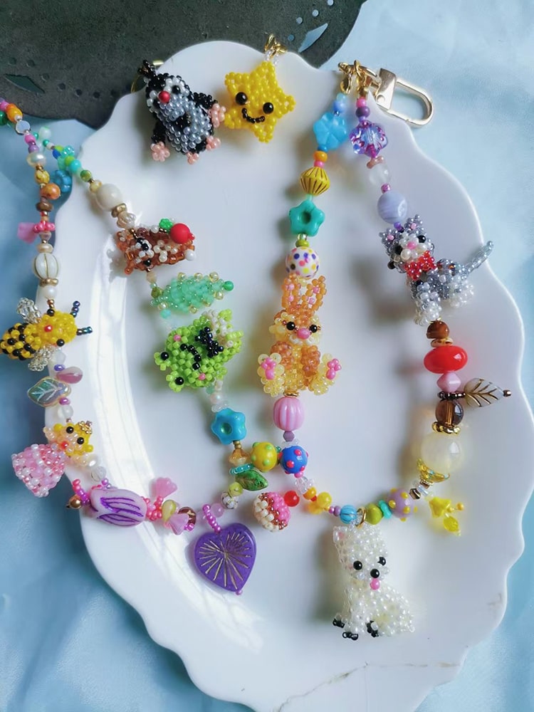 Colorful beaded keychains on a white plate with a blue background