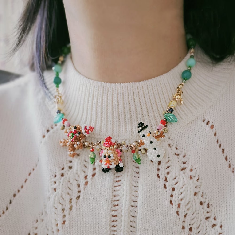 Colorful beaded necklace worn by a person on a white sweater- verhalo custom jewelry