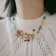 Colorful beaded necklace worn by a person on a white sweater- verhalo custom jewelry