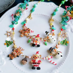 Colorful beaded Christmas-themed necklaces on a white plate - verhalo custom jewelry