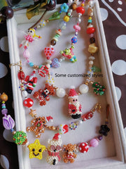Colorful beaded jewelry on a white tray with a polka dot background- verhalo custom jewelry