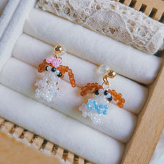 handmade Pair of small puppy earrings with colorful beads on a white cushion- verhalojewelry