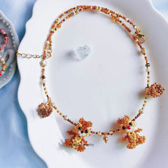 Necklace with squirrel  pendants on a white dish - verhalo custom jewelry